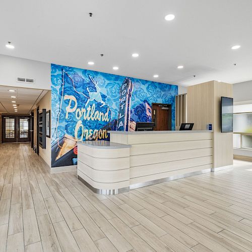 A modern reception area with a mural saying 